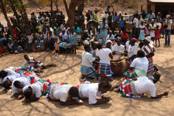 Drum ceremony with gathered people watching.