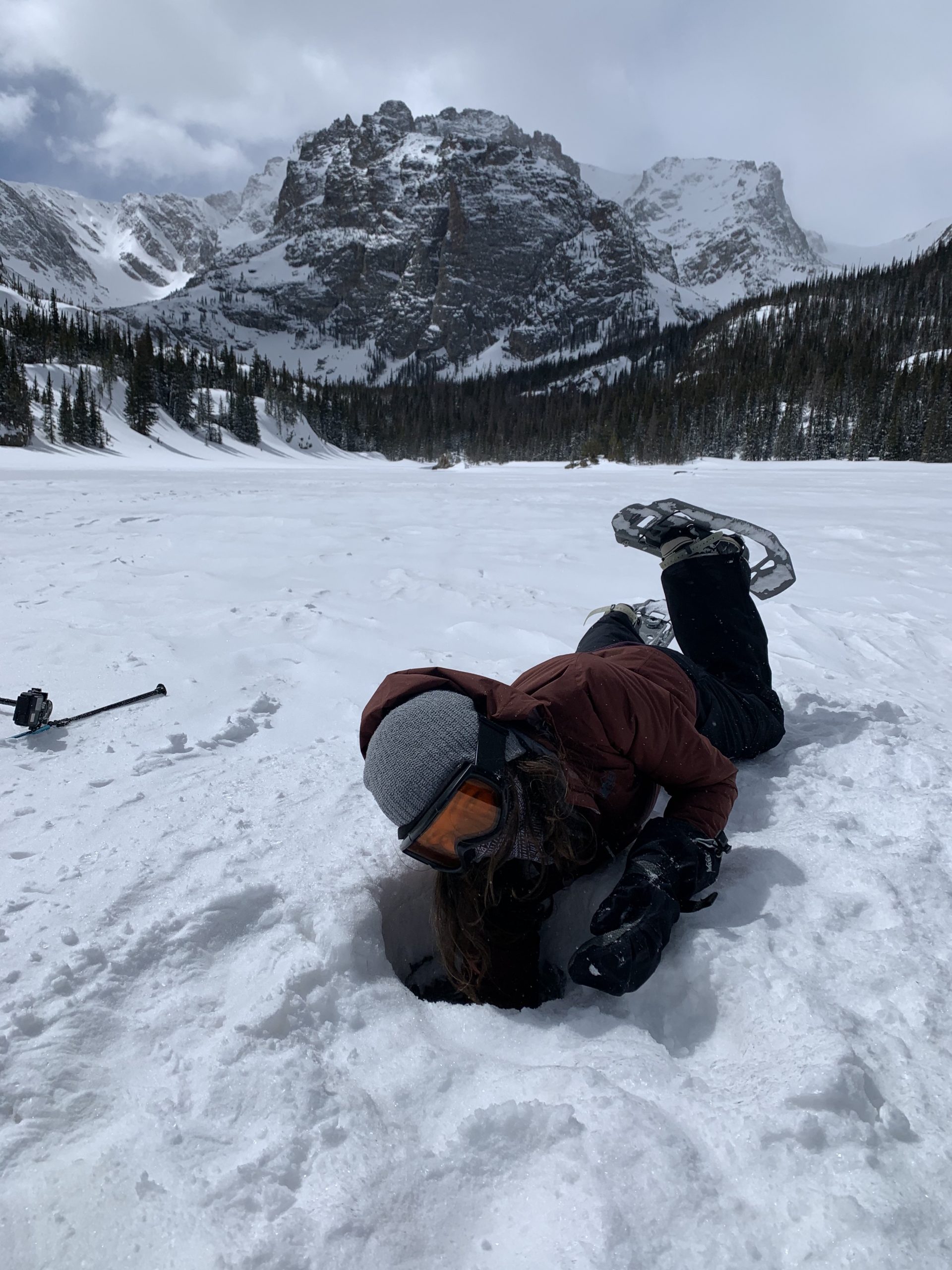 LeAnna digging snow out of an ice auger hole on The Loch.