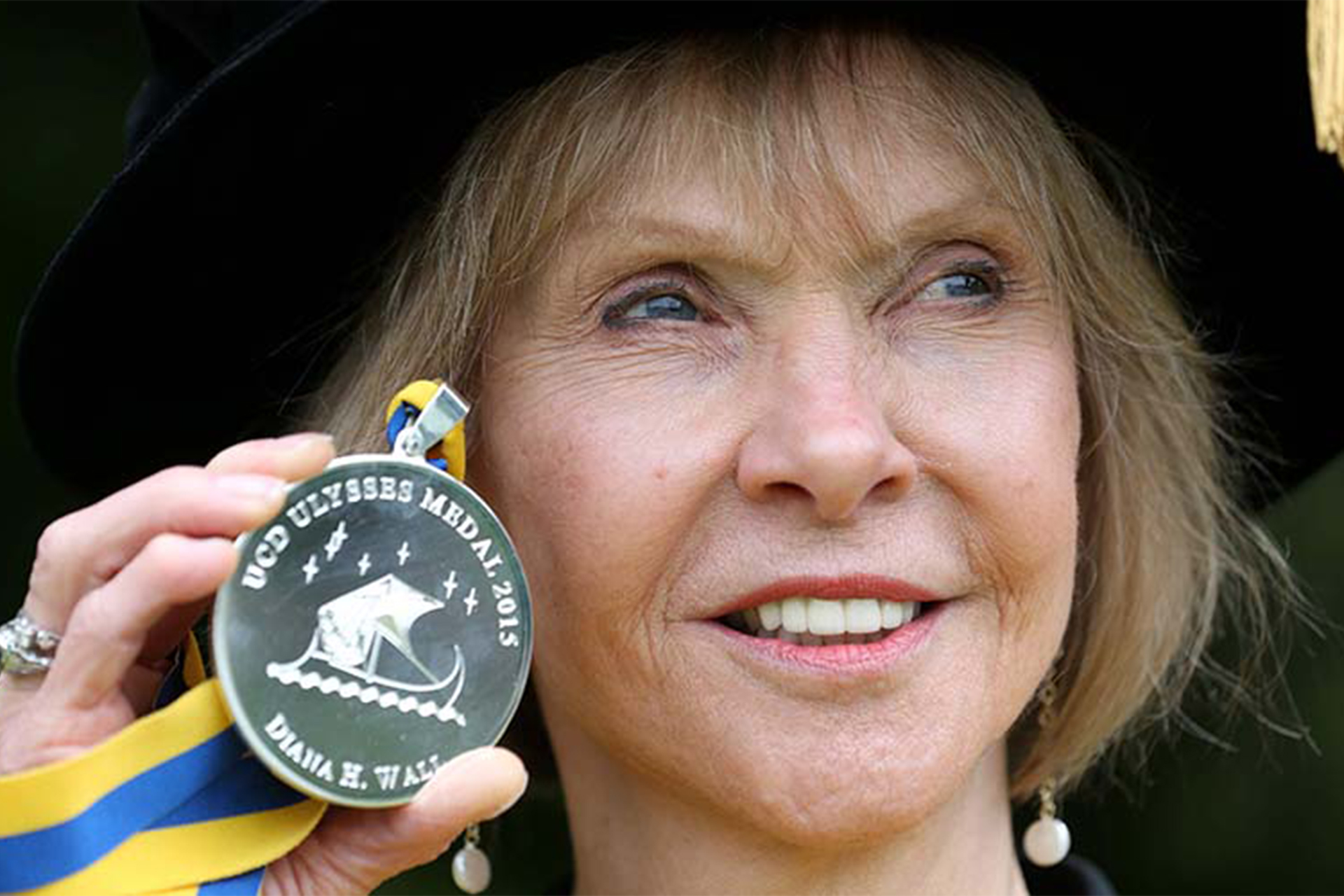 Diana Wall holding Ulysses medal